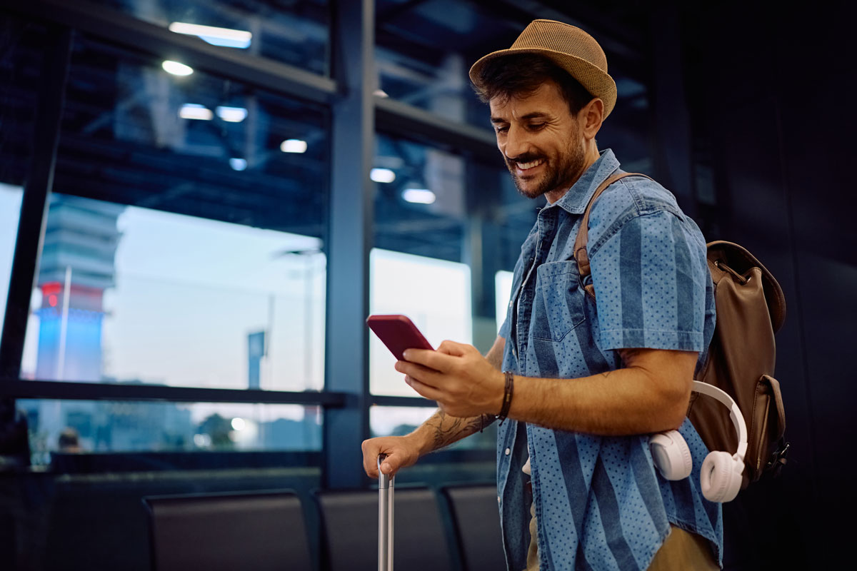 Tour-Operator-Website-Engagement-by-2030-featured-image man looking at phone at airport