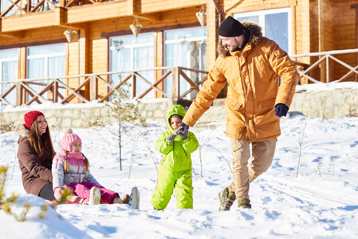 family on vacation in the snow outside