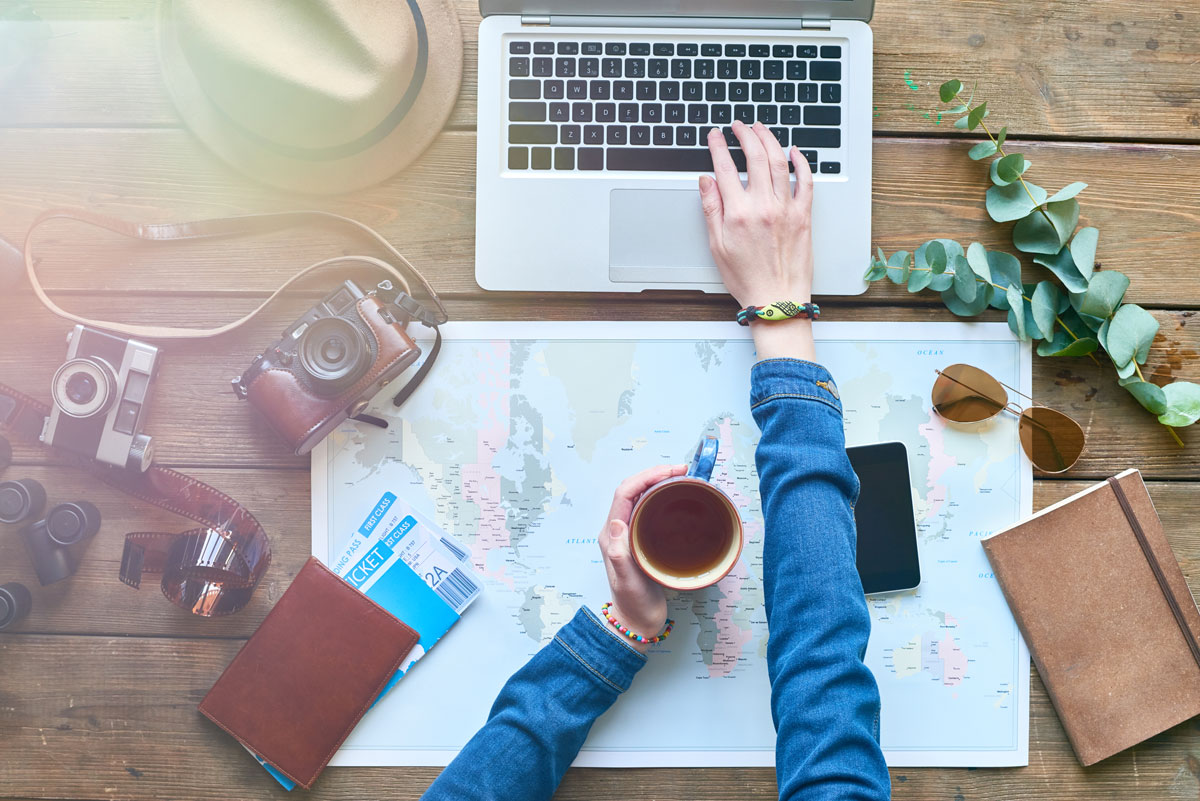 image of person planning trip aboard while using a laptop