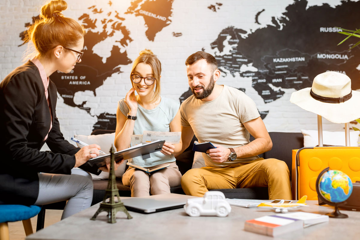 couple talking to a traval planner about a up and coming trip